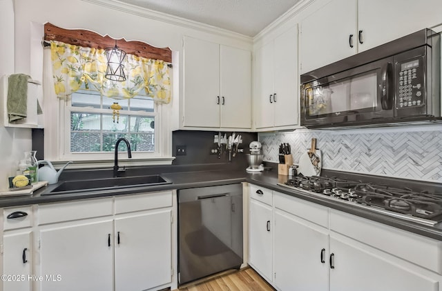 1409 Knollwood Dr NW, Wilson, NC 27896 - kitchen with black appliances, a sink, dark countertops, and decorative backsplash