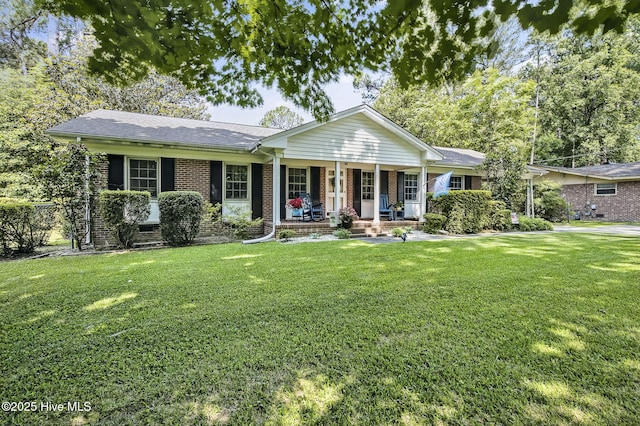 1409 Knollwood Dr NW, Wilson, NC 27896 - ranch-style home featuring a porch, a front lawn, and brick siding