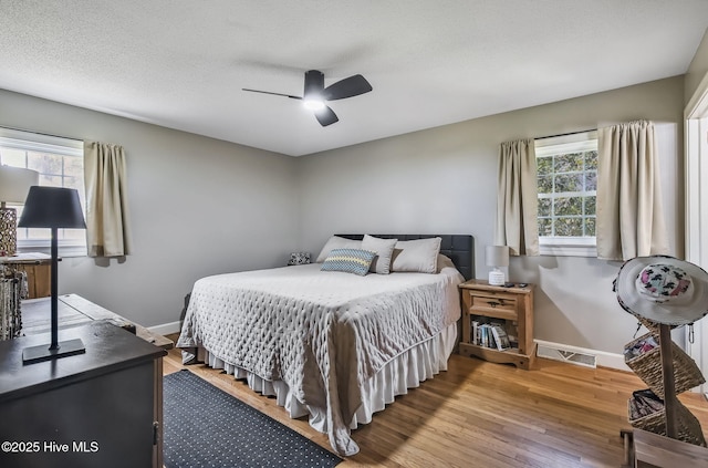 1409 Knollwood Dr NW, Wilson, NC 27896 - bedroom featuring baseboards, wood finished floors, and a ceiling fan