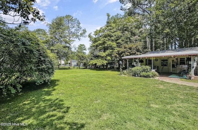 1409 Knollwood Dr NW, Wilson, NC 27896 - view of grassy yard featuring a patio area