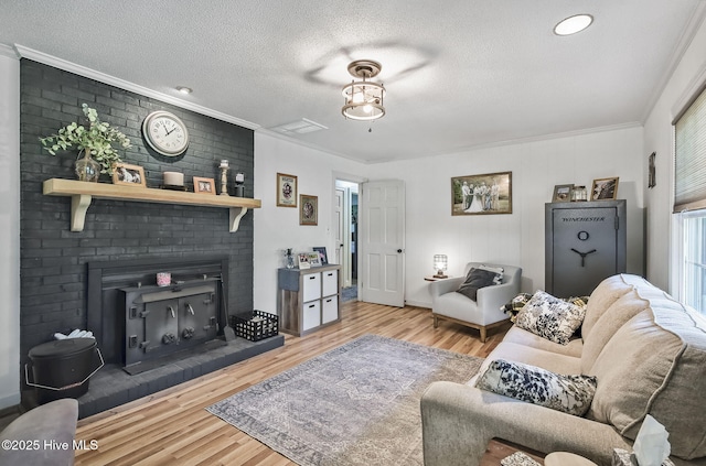 1409 Knollwood Dr NW, Wilson, NC 27896 - living room featuring ornamental molding, wood finished floors, a fireplace, and a textured ceiling