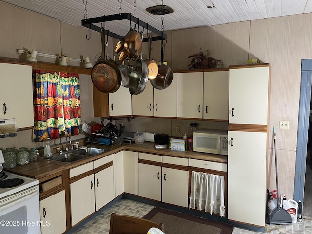136 Avoca Farm Rd, Merry Hill, NC 27957 - kitchen with white appliances, a sink, brick patterned floors, white cabinetry, and dark countertops