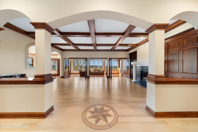6424 River Vista Dr, Wilmington, NC 28412 - unfurnished living room featuring ornate columns, light wood-type flooring, coffered ceiling, baseboards, and beam ceiling