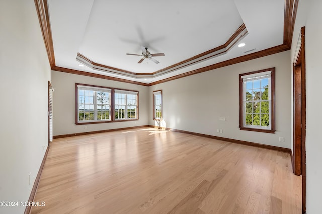 6424 River Vista Dr, Wilmington, NC 28412 - spare room featuring plenty of natural light, ornamental molding, ceiling fan, a raised ceiling, and light wood-type flooring