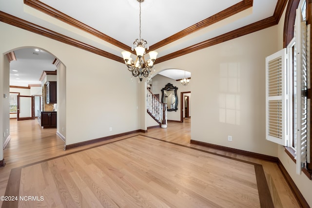 6424 River Vista Dr, Wilmington, NC 28412 - unfurnished room with ornamental molding, light wood-style floors, arched walkways, a chandelier, and baseboards