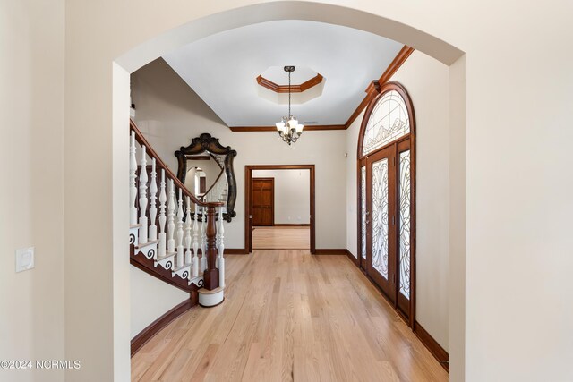 6424 River Vista Dr, Wilmington, NC 28412 - entrance foyer featuring arched walkways, light wood-style floors, baseboards, stairs, and crown molding