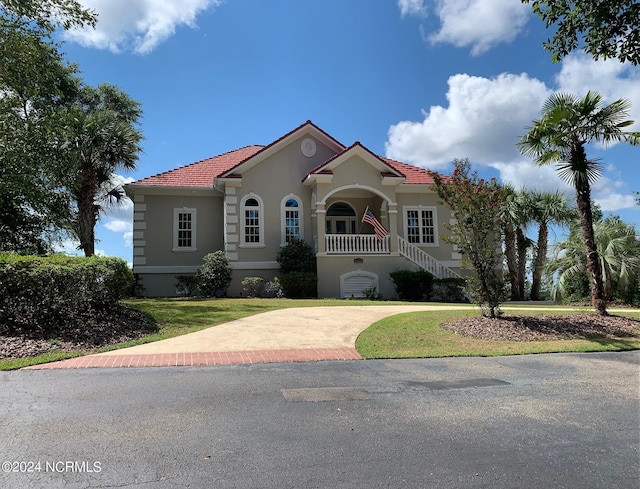 6424 River Vista Dr, Wilmington, NC 28412 - mediterranean / spanish house with stucco siding, a front yard, and stairs