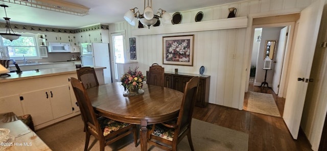 301 Graham St, Clinton, NC 28328 - dining space featuring dark wood-style flooring and a chandelier