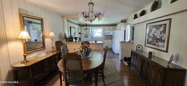 301 Graham St, Clinton, NC 28328 - dining space featuring dark wood finished floors and a chandelier