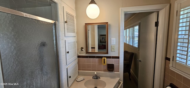 301 Graham St, Clinton, NC 28328 - full bath featuring tile walls, a shower stall, healthy amount of natural light, a wainscoted wall, and vanity
