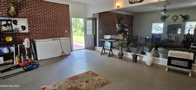 301 Graham St, Clinton, NC 28328 - interior space featuring heating unit, ceiling fan, finished concrete floors, and plenty of natural light