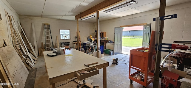 301 Graham St, Clinton, NC 28328 - home office with unfinished concrete flooring, concrete block wall, and a workshop area