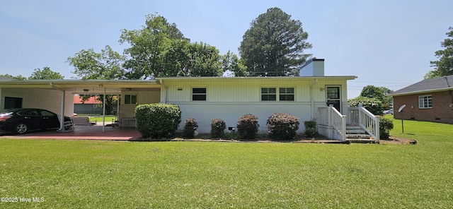 301 Graham St, Clinton, NC 28328 - view of front of property with a chimney, a front yard, a carport, and brick siding