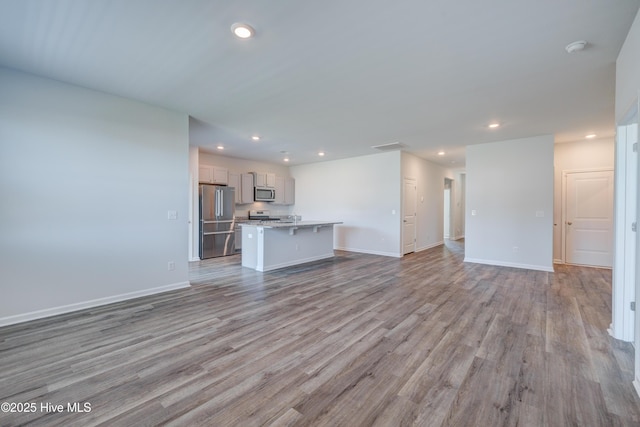5380 Black Oak Ct, Winnabow, NC 28479 - unfurnished living room featuring wood finished floors and recessed lighting
