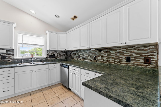 126 NE 5th St, Oak Island, NC 28465 - kitchen with a sink, dishwasher, lofted ceiling, dark countertops, and light tile patterned floors