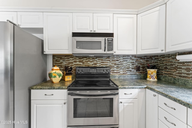 126 NE 5th St, Oak Island, NC 28465 - kitchen with appliances with stainless steel finishes, white cabinetry, decorative backsplash, and dark countertops