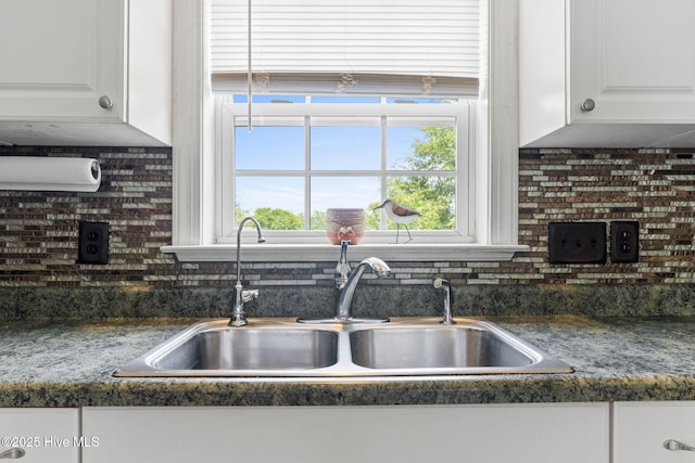 126 NE 5th St, Oak Island, NC 28465 - detailed view of a sink, white cabinets, and decorative backsplash