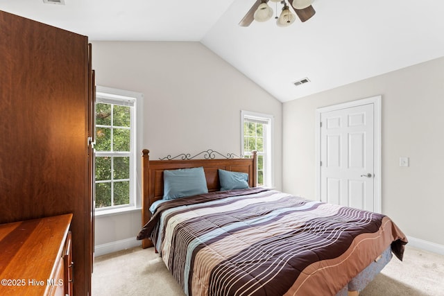 126 NE 5th St, Oak Island, NC 28465 - bedroom with light colored carpet, lofted ceiling, baseboards, and ceiling fan