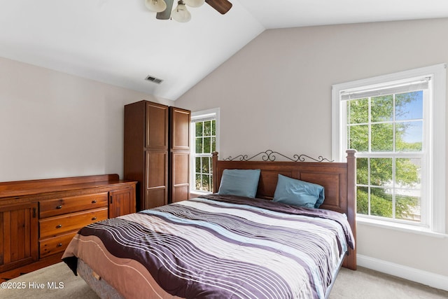 126 NE 5th St, Oak Island, NC 28465 - bedroom featuring lofted ceiling, multiple windows, light colored carpet, baseboards, and ceiling fan