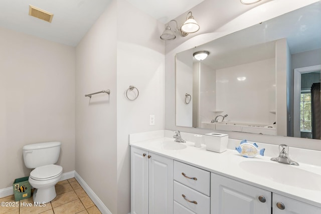 126 NE 5th St, Oak Island, NC 28465 - bathroom with toilet, double vanity, baseboards, and tile patterned flooring