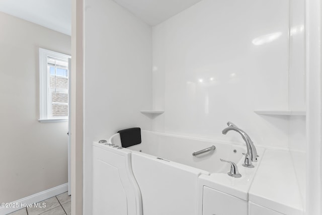 126 NE 5th St, Oak Island, NC 28465 - full bath with a tub to relax in, tile patterned floors, and baseboards