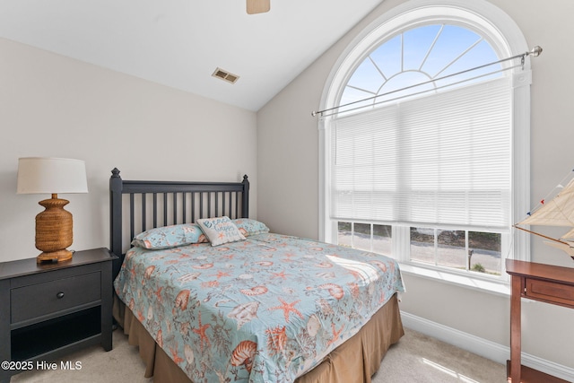 126 NE 5th St, Oak Island, NC 28465 - bedroom with light colored carpet, lofted ceiling, baseboards, and a ceiling fan