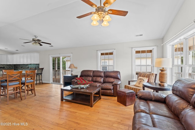 126 NE 5th St, Oak Island, NC 28465 - living room featuring ceiling fan, vaulted ceiling, and light wood-type flooring