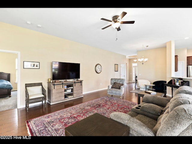 1232 Fence Post Ln, Carolina Shores, NC 28467 - living room featuring dark wood finished floors, a chandelier, a ceiling fan, and baseboards