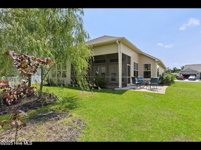 1232 Fence Post Ln, Carolina Shores, NC 28467 - back of house with a patio, a sunroom, and a yard