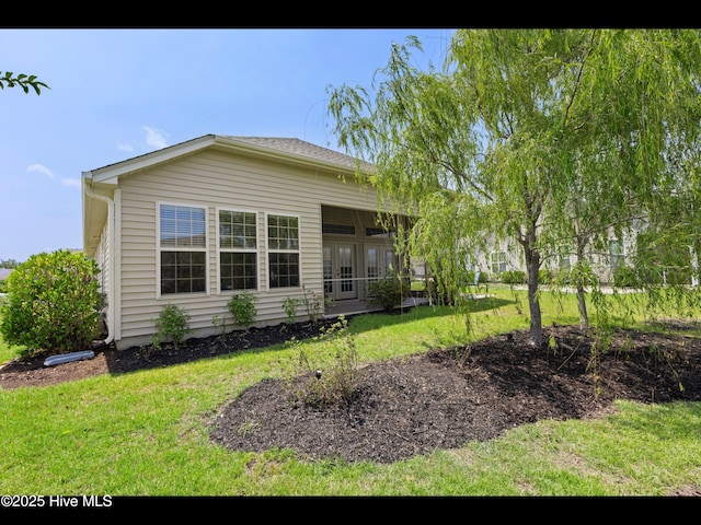 1232 Fence Post Ln, Carolina Shores, NC 28467 - rear view of property with a yard and french doors