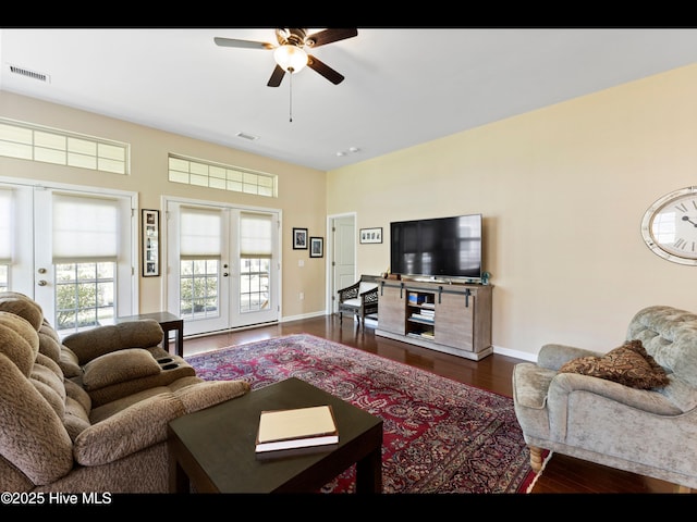 1232 Fence Post Ln, Carolina Shores, NC 28467 - living room featuring french doors, dark wood-style floors, ceiling fan, and baseboards