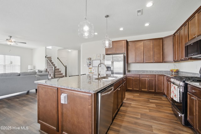 122 Mill Run Loop, South Mills, NC 27976 - kitchen featuring appliances with stainless steel finishes, dark wood finished floors, a sink, ceiling fan, and light stone counters
