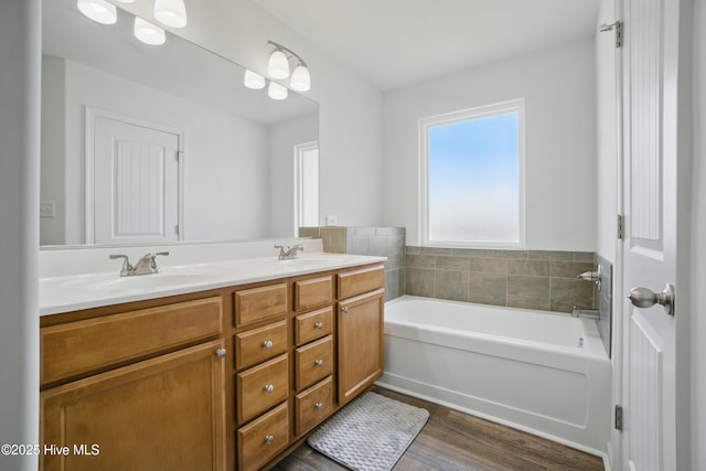122 Mill Run Loop, South Mills, NC 27976 - bathroom featuring a garden tub, wood finished floors, and double vanity