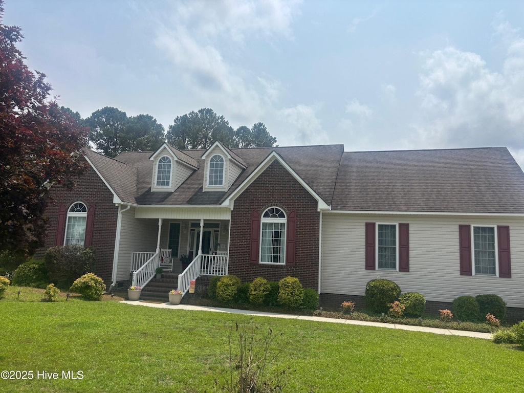 216 La Salle St, Wilmington, NC 28411 - view of front of property with a porch, a front yard, brick siding, and a shingled roof
