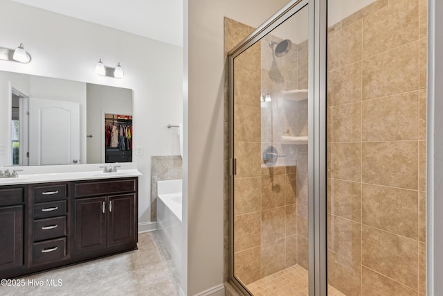 6005 Otter Tail Trl, Wilmington, NC 28412 - bathroom with a garden tub, a stall shower, double vanity, and a walk in closet