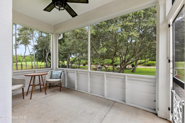6005 Otter Tail Trl, Wilmington, NC 28412 - unfurnished sunroom featuring a ceiling fan, healthy amount of natural light, and view of wooded area