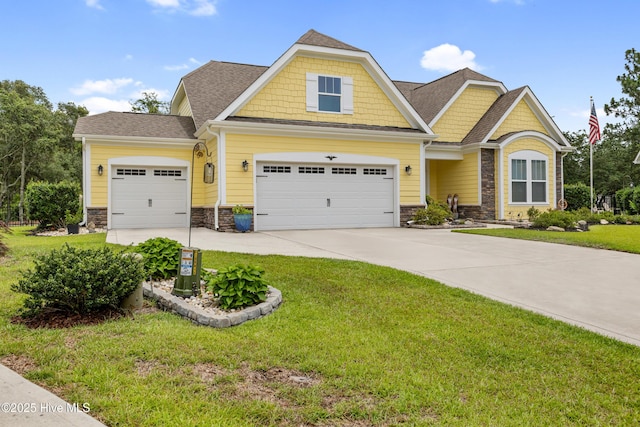 6005 Otter Tail Trl, Wilmington, NC 28412 - craftsman house featuring stone siding, concrete driveway, a front yard, a garage, and roof with shingles