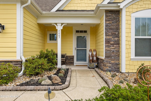 6005 Otter Tail Trl, Wilmington, NC 28412 - property entrance featuring roof with shingles and stone siding