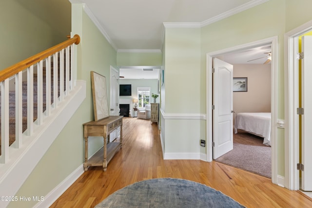 6005 Otter Tail Trl, Wilmington, NC 28412 - hallway with light wood-type flooring, ornamental molding, and stairs