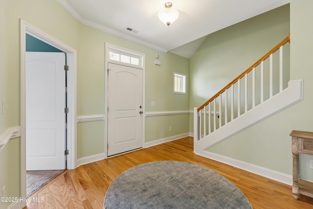6005 Otter Tail Trl, Wilmington, NC 28412 - entrance foyer featuring wood finished floors, crown molding, and stairs