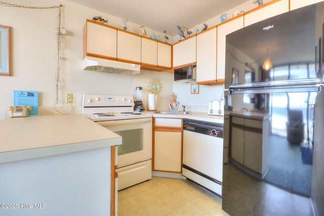 1615 Lake Park Blvd S Unit 307, Carolina Beach, NC 28428 - kitchen featuring black appliances, under cabinet range hood, light countertops, light flooring, and a sink
