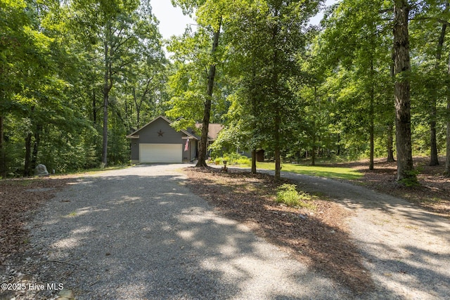 108 Western Trl, Carthage, NC 28327 - view of property hidden behind natural elements featuring gravel driveway and a garage