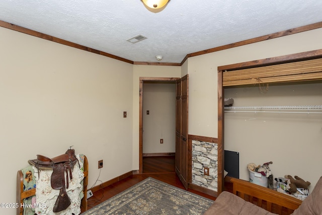 108 Western Trl, Carthage, NC 28327 - bedroom with a closet, wood finished floors, a textured ceiling, baseboards, and ornamental molding