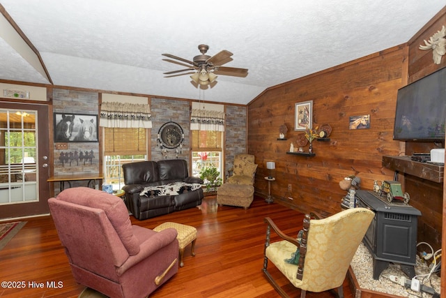 108 Western Trl, Carthage, NC 28327 - living room featuring lofted ceiling, a ceiling fan, a wood stove, wood finished floors, and a textured ceiling