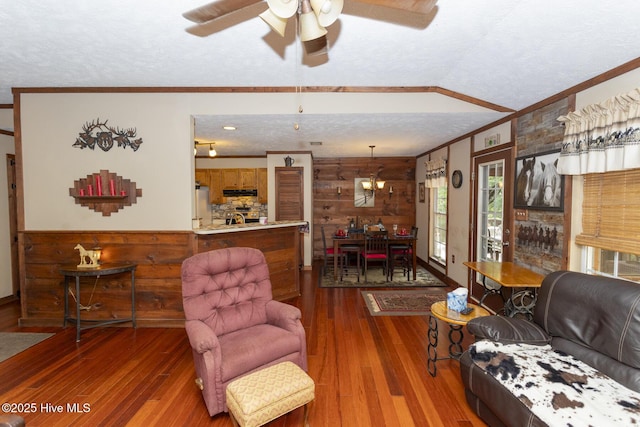 108 Western Trl, Carthage, NC 28327 - living area with crown molding, wood walls, a ceiling fan, wood-type flooring, and a textured ceiling