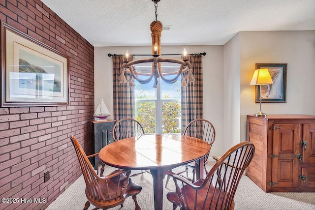 3350 Club Villas Dr # 105, Southport, NC 28461 - carpeted dining space with a chandelier, brick wall, and a textured ceiling