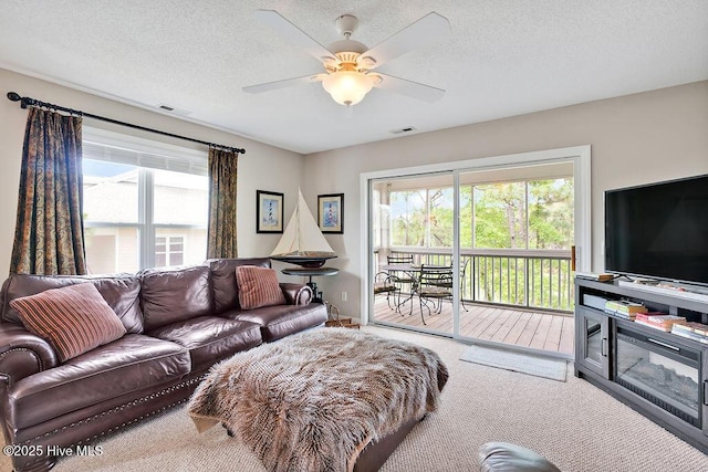 3350 Club Villas Dr # 105, Southport, NC 28461 - carpeted living area with healthy amount of natural light, ceiling fan, and a textured ceiling