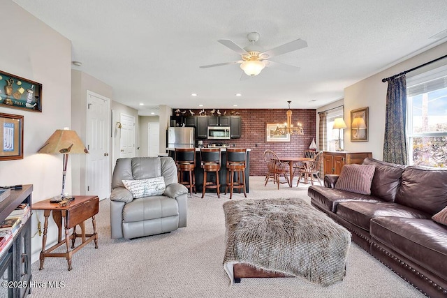 3350 Club Villas Dr # 105, Southport, NC 28461 - living room featuring light carpet, brick wall, ceiling fan, and a chandelier