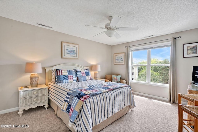 3350 Club Villas Dr # 105, Southport, NC 28461 - bedroom with light colored carpet, a textured ceiling, baseboards, and ceiling fan