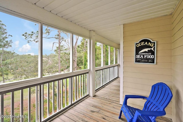 3350 Club Villas Dr # 105, Southport, NC 28461 - sunroom featuring wooden walls and wood-type flooring